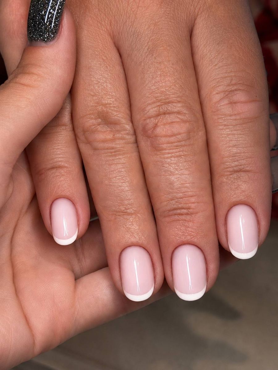 Classic French manicure with crisp white tips over a soft pink base