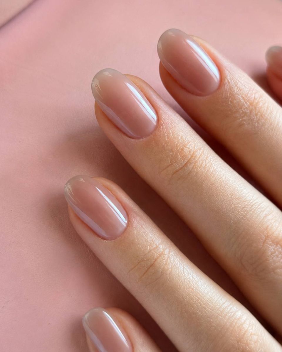 The artist's signature finish — a glazed natural manicure with a sheer blush tone