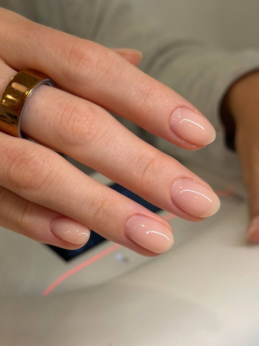 Short natural manicure with a sculpted peach-nude gel overlay